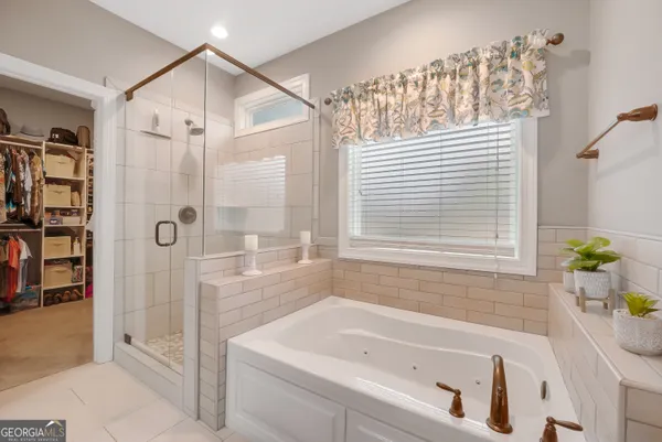 a bathroom with a tub shower and sink
