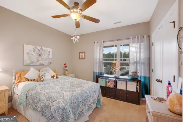 a bed room with a bed and a chandelier