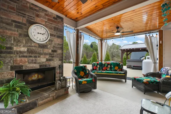 a living room with furniture a clock and a fireplace