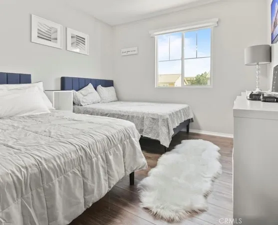 a bedroom with two beds and a window