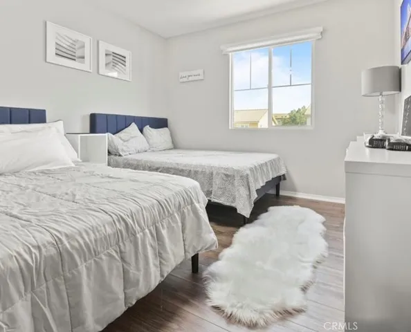 a bedroom with two beds and a window