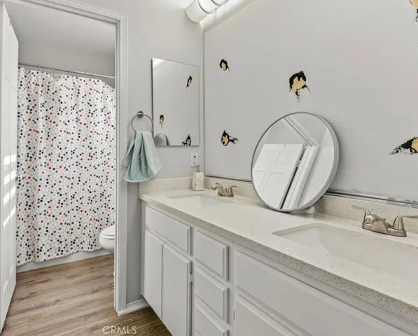 a bathroom with a double vanity sink and a mirror