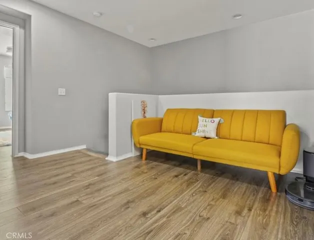 a blue and white sitting area with wooden floor