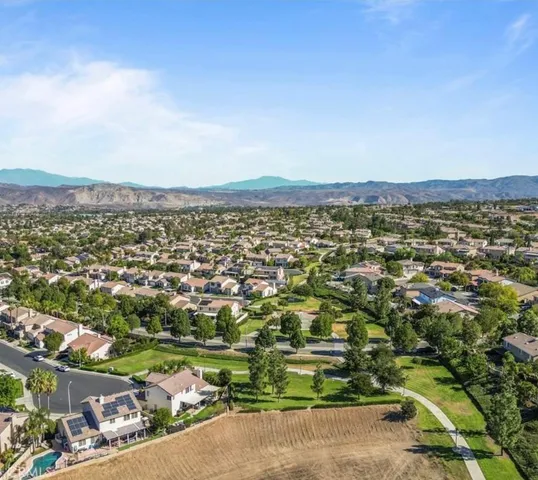 an aerial view of residential houses with city view