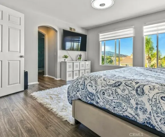 a bedroom with a large bed and a dresser