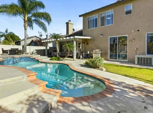 a swimming pool with outdoor seating and yard