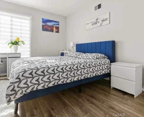 a bedroom with a bed and a dresser