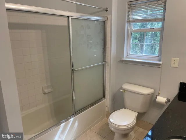 a white toilet sitting next to a bath tub