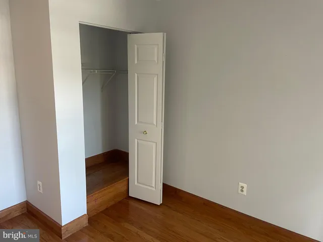 a view of an empty room and wooden floor