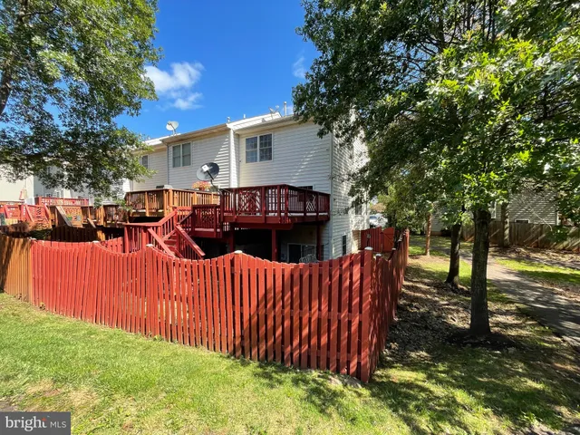 a view of a house with a wooden fence