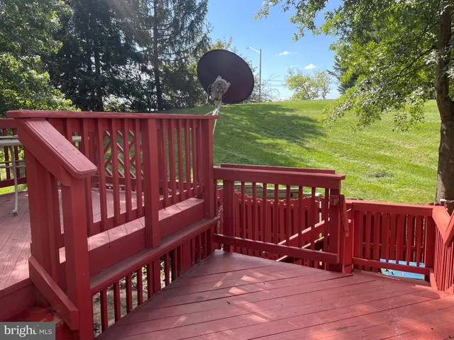 a view of a wooden deck with a backyard