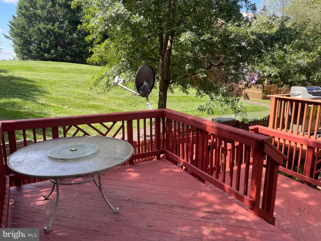 a balcony with table and chairs