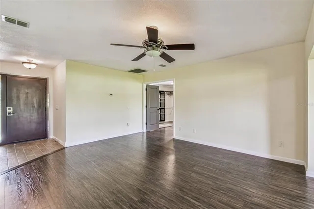 wooden floor in an empty room with a window