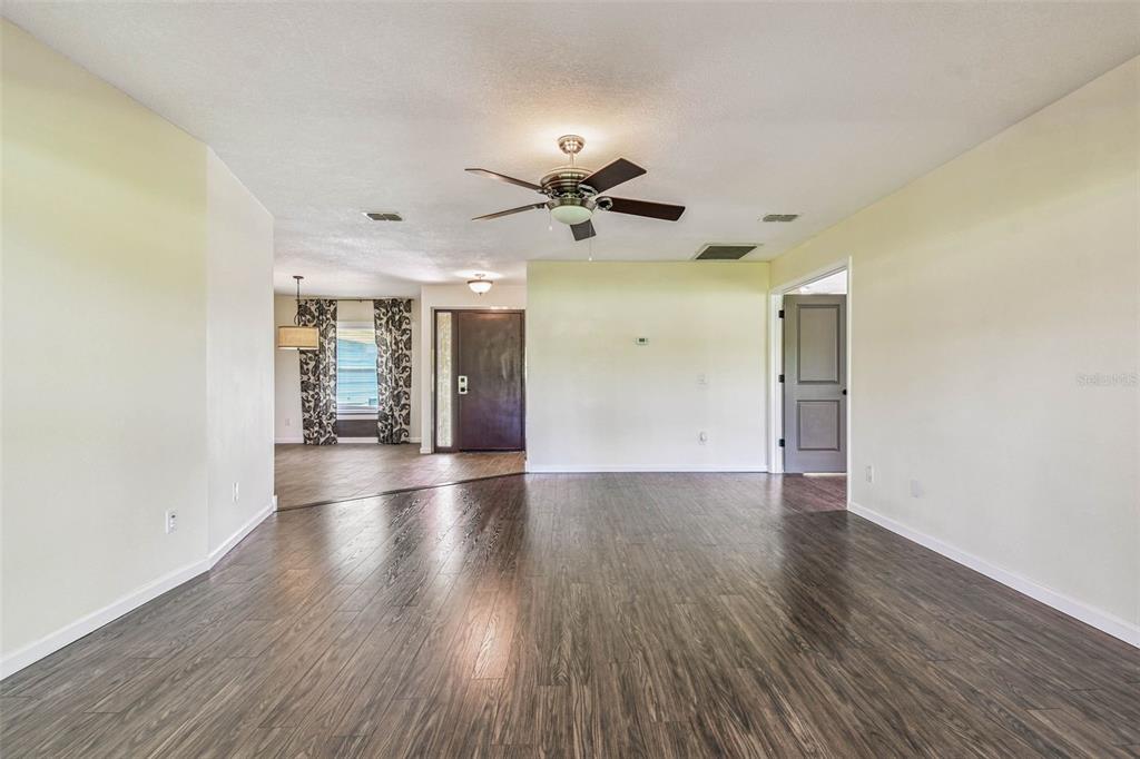 5319 Saddlebrook Way Wesley Chapel, FL 33543 - Photo 12 of 77 wooden floor in an empty room with a window