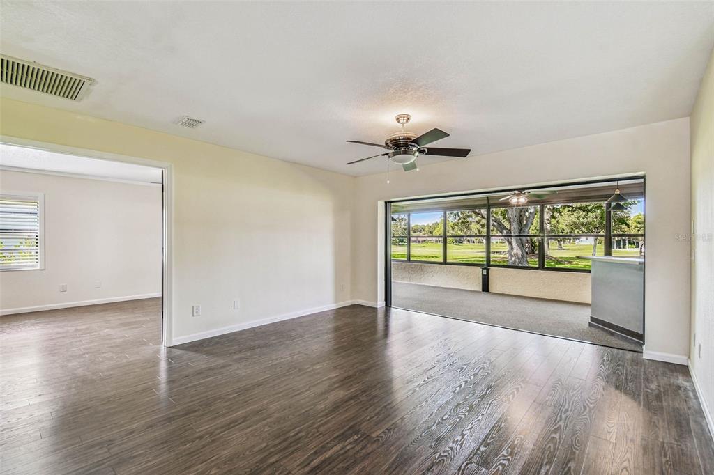 5319 Saddlebrook Way Wesley Chapel, FL 33543 - Photo 14 of 77 a view of an empty room with wooden floor and a window