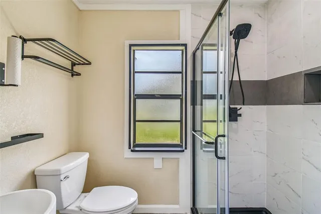 a living room with furniture a fireplace and a potted plant