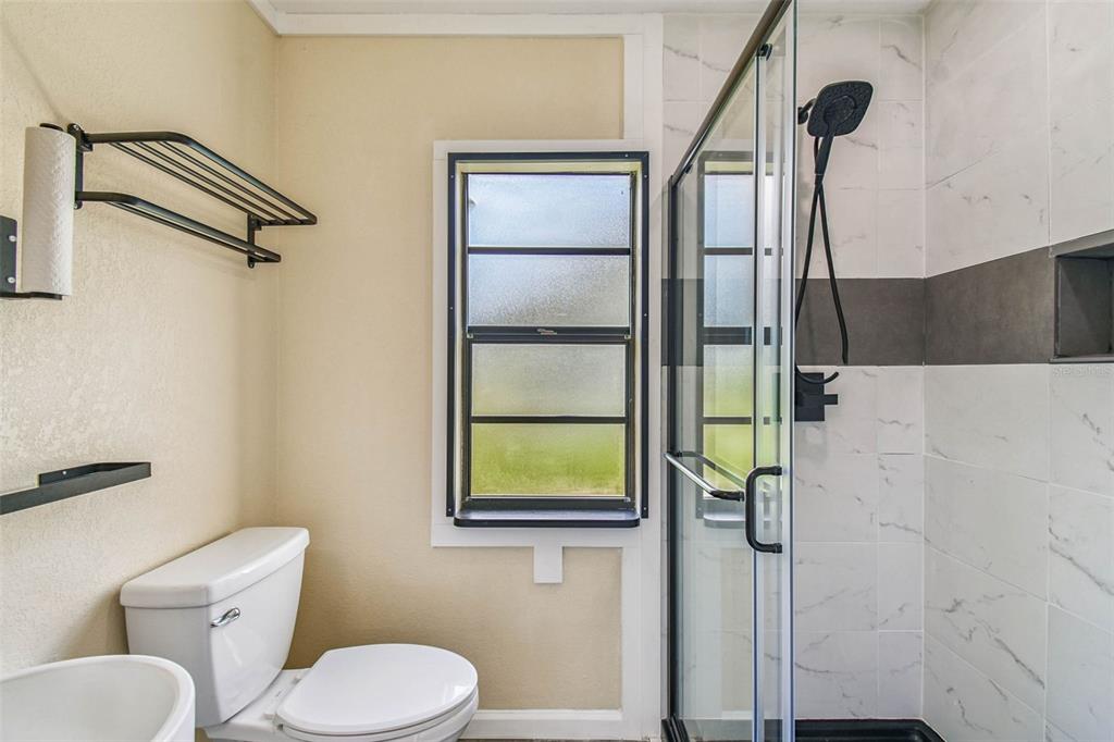 5319 Saddlebrook Way Wesley Chapel, FL 33543 - Photo 24 of 77 a bathroom with a toilet sink and shower