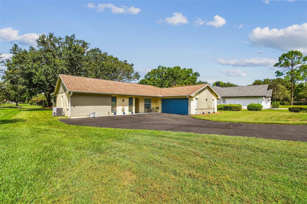 5319 Saddlebrook Way Wesley Chapel, FL 33543 - Photo 3 of 77 a front view of a house with a yard