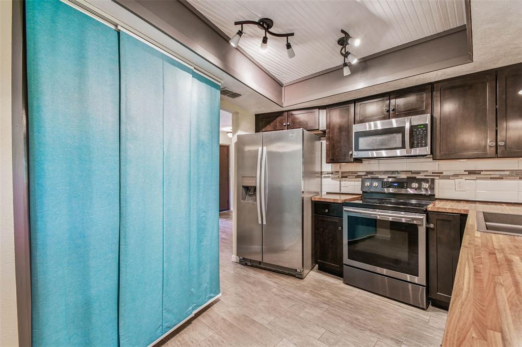 5319 Saddlebrook Way Wesley Chapel, FL 33543 - Photo 33 of 77 a kitchen with stainless steel appliances granite countertop a stove and a refrigerator