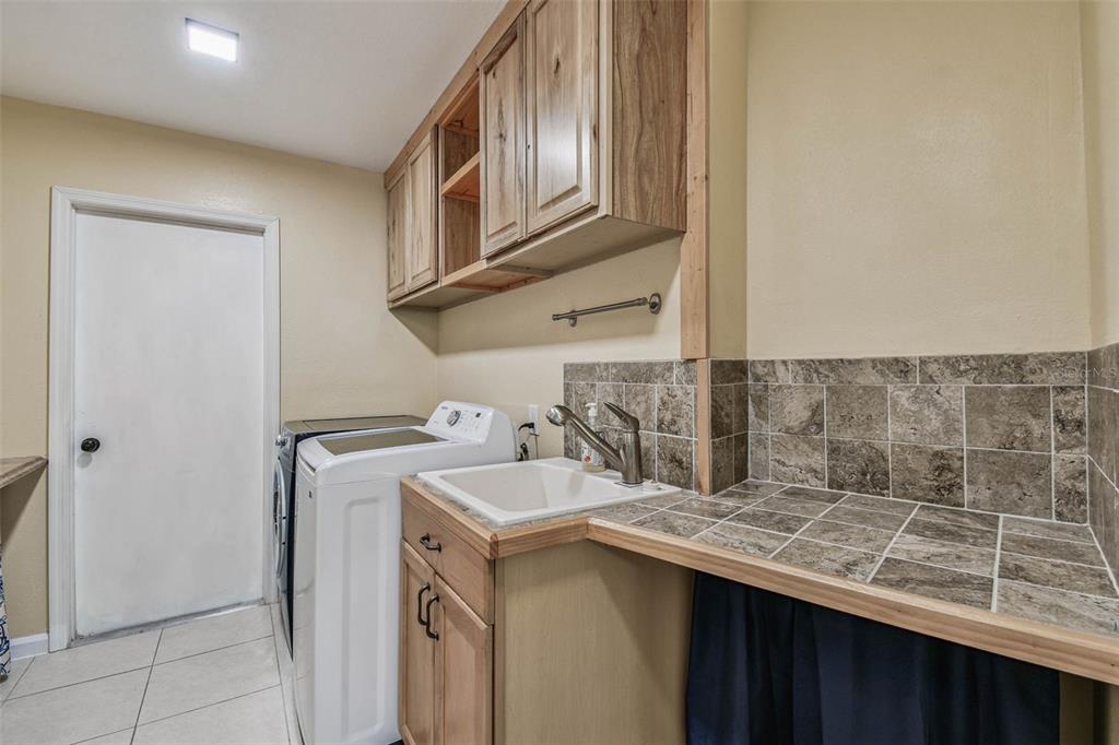 5319 Saddlebrook Way Wesley Chapel, FL 33543 - Photo 41 of 77 a kitchen with a sink and a refrigerator