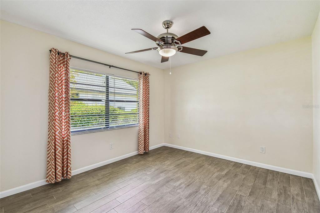 5319 Saddlebrook Way Wesley Chapel, FL 33543 - Photo 43 of 77 a view of an empty room with wooden floor and a window