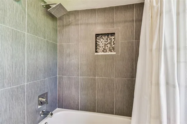 an aerial view of a house with a yard and lake view