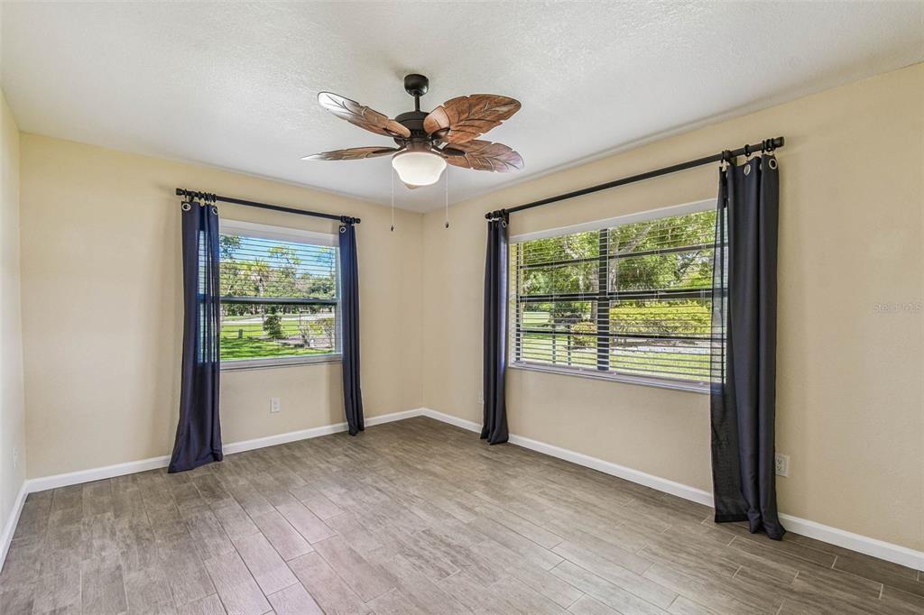 5319 Saddlebrook Way Wesley Chapel, FL 33543 - Photo 49 of 77 a view of an empty room with a window and wooden floor