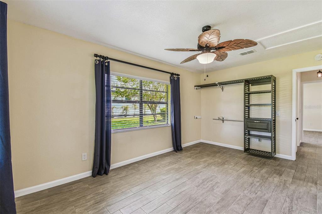 5319 Saddlebrook Way Wesley Chapel, FL 33543 - Photo 50 of 77 a view of empty room with wooden floor and fan