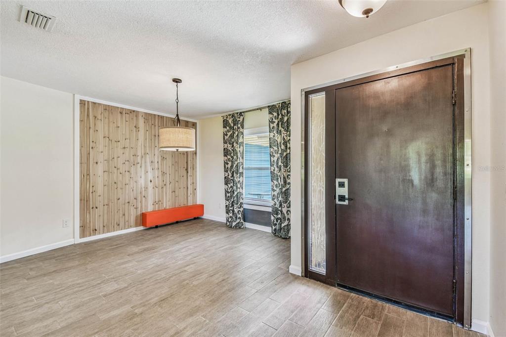 5319 Saddlebrook Way Wesley Chapel, FL 33543 - Photo 8 of 77 a view of an empty room with closet and wooden floor
