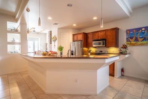 a kitchen with stainless steel appliances granite countertop a sink and a stove