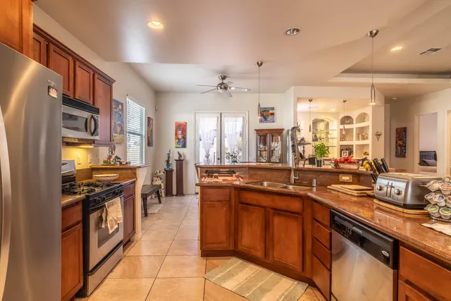 a kitchen with stainless steel appliances granite countertop a sink and a stove