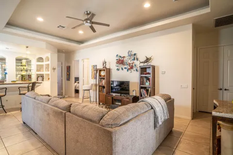 a living room with furniture and chandelier