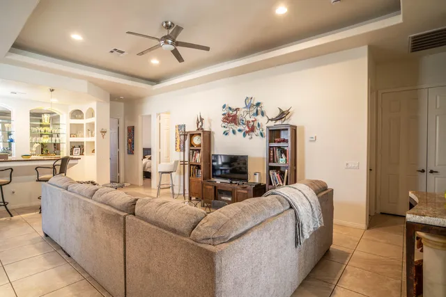 a living room with furniture and chandelier