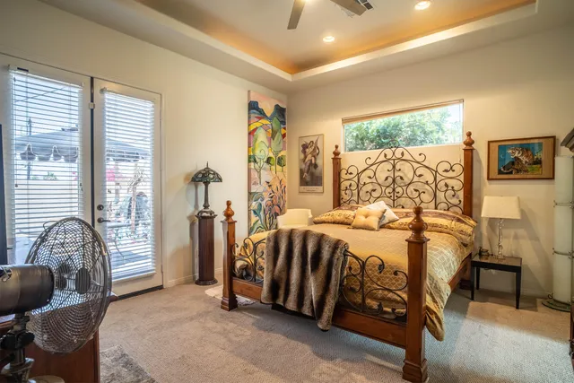 a bedroom with a bed and a painting on the wall