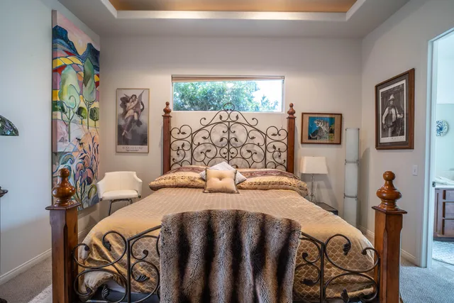 a bedroom with a bed and a dresser