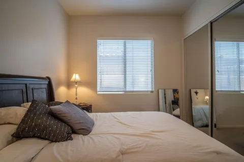 a bedroom with bed and wall painting
