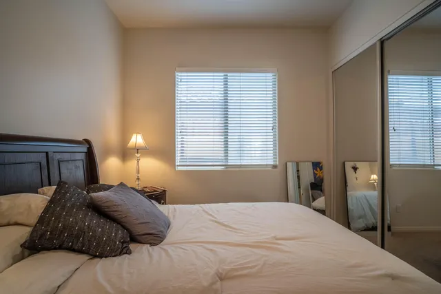 a bedroom with bed and wall painting