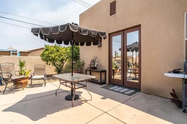 a view of a patio with table and chairs potted plants with wooden floor
