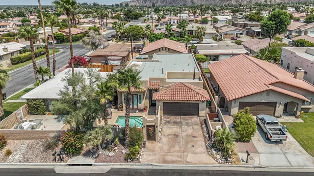 an aerial view of a residential building with an outdoor space