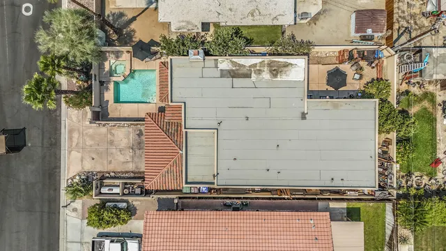 an aerial view of a house with a mountain
