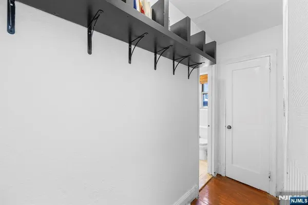 a view of hallway with stairs and wooden floor
