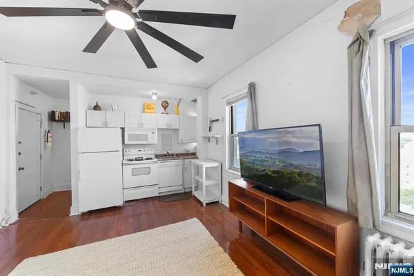 a kitchen with stainless steel appliances kitchen island a refrigerator and a stove top oven
