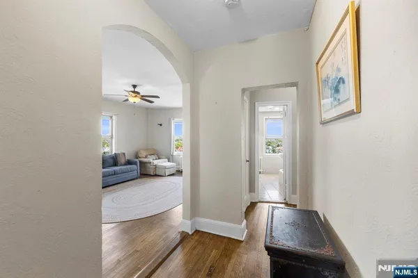 a view of a hallway to a livingroom and a couch