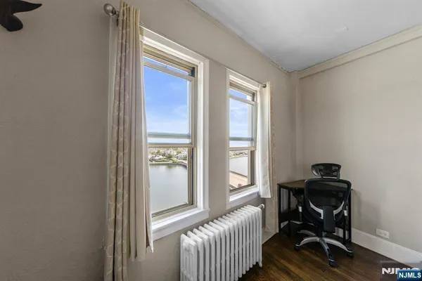 a view of a workspace with furniture and a window