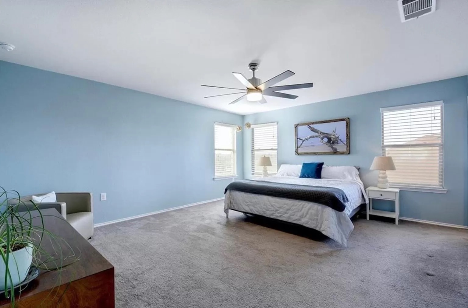 9016 Ridgewell Road Austin, TX 78747 - Photo 23 of 30 An airy primary bedroom awaits, featuring plush carpeting and generous natural light.