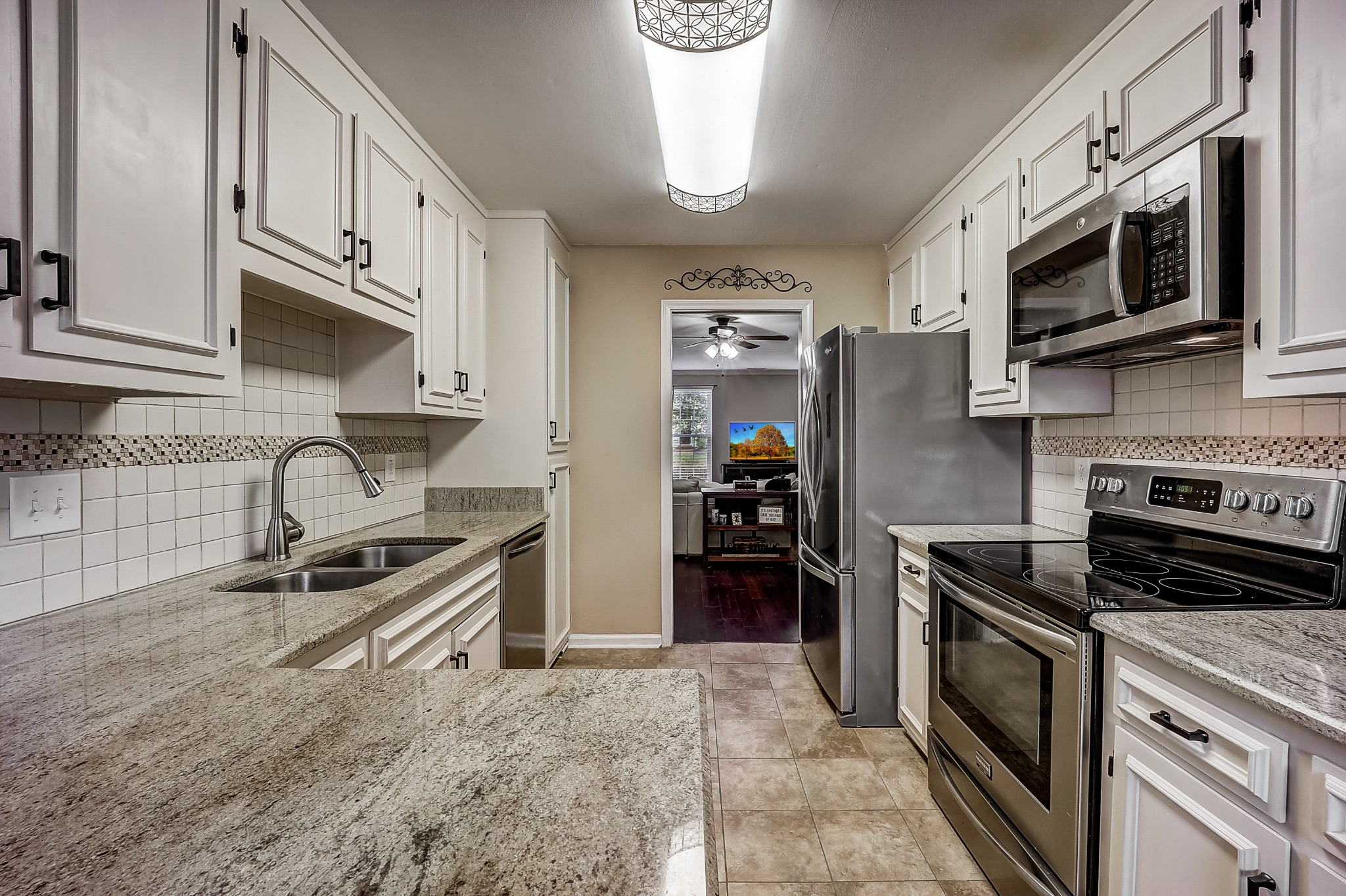 922 General George Patton Road Nashville, TN 37221 - Photo 11 of 30 a kitchen with stainless steel appliances granite countertop a stove and a refrigerator