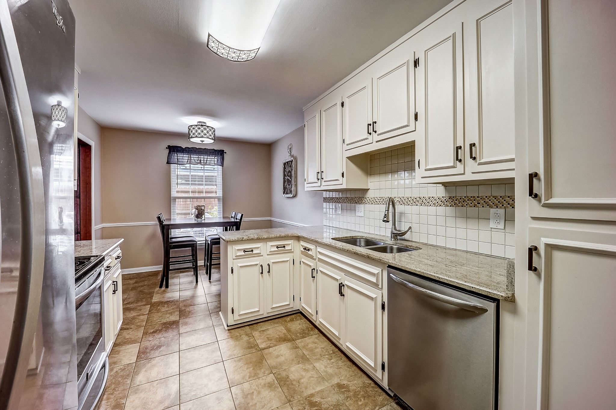 922 General George Patton Road Nashville, TN 37221 - Photo 13 of 30 a kitchen with stainless steel appliances granite countertop a sink stove and cabinets