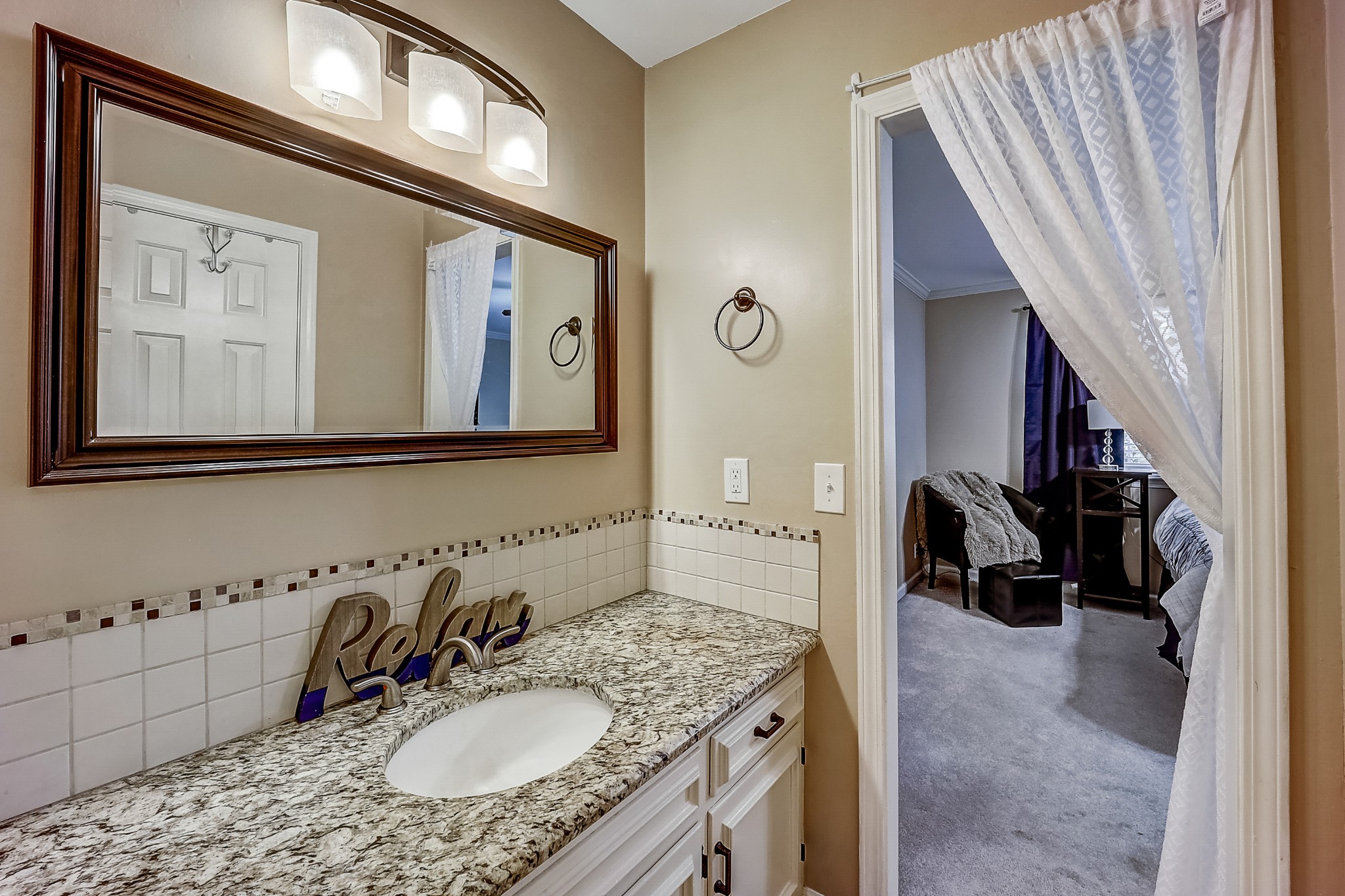 922 General George Patton Road Nashville, TN 37221 - Photo 16 of 30 a en suite bathroom with a granite countertop sink and a mirror