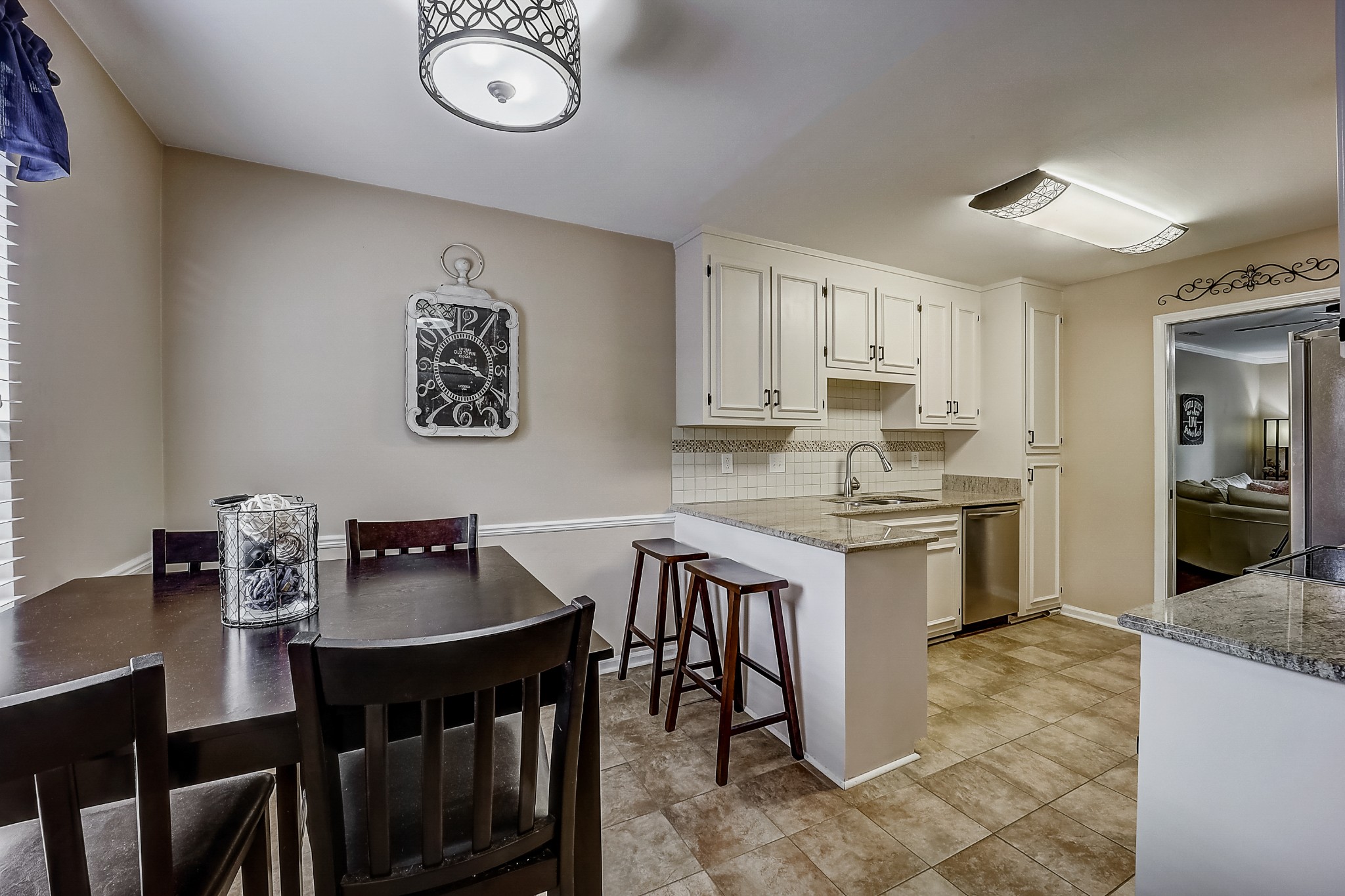 922 General George Patton Road Nashville, TN 37221 - Photo 10 of 30 a kitchen with granite countertop a table chairs stove and cabinets