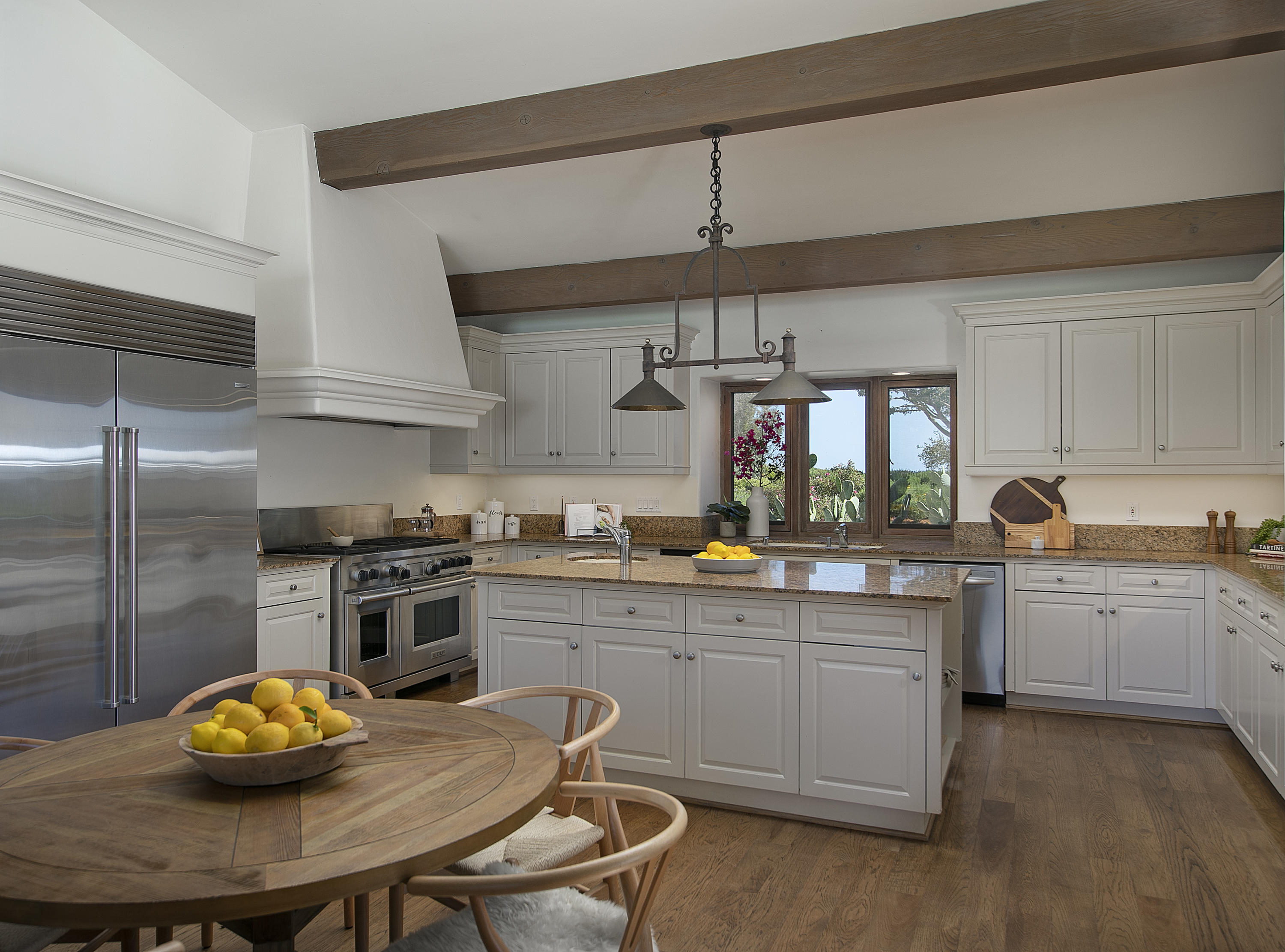 2250 Ortega Ranch Road Summerland, CA 93067 - Photo 13 of 28 a kitchen with stainless steel appliances a sink a stove a table and chairs